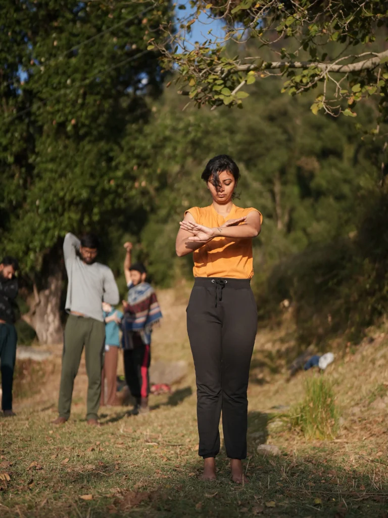 Facilitator guiding embodiment practice in nature during Conscious Movement TTC in Himachal Pradesh